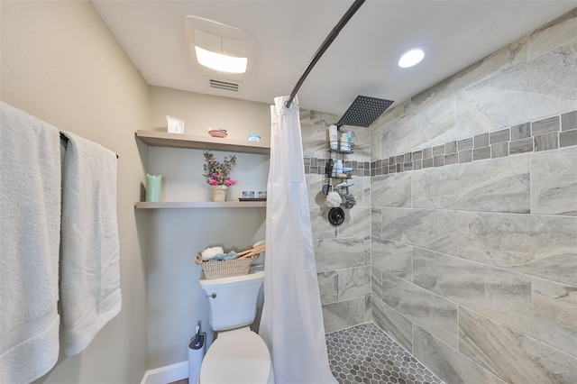 bathroom with toilet and a shower with shower curtain