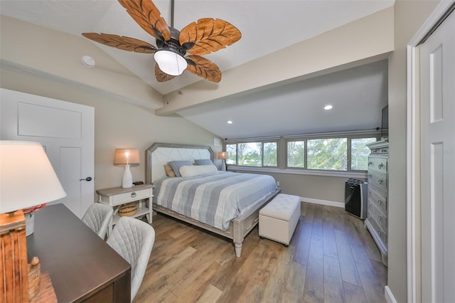 bedroom with light hardwood / wood-style flooring, vaulted ceiling, and ceiling fan