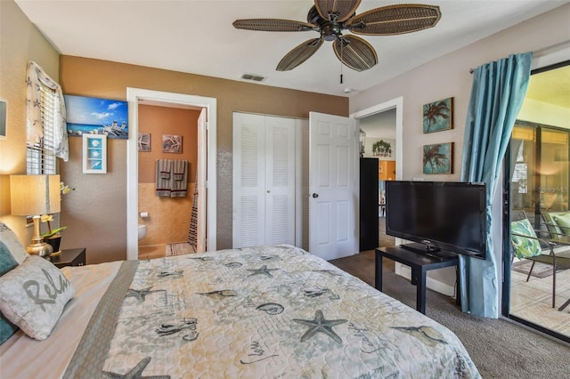 bedroom featuring ceiling fan, dark carpet, access to exterior, and ensuite bath