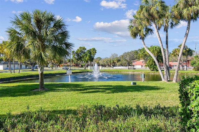 surrounding community featuring a lawn and a water view