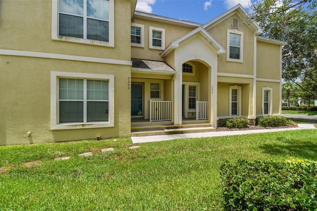 view of front of home with a front yard and a porch