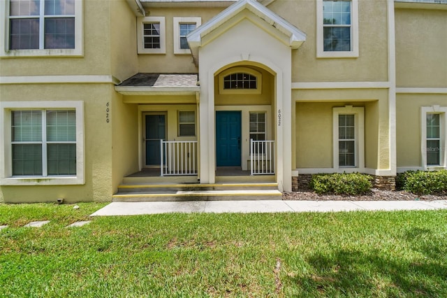 doorway to property featuring a yard