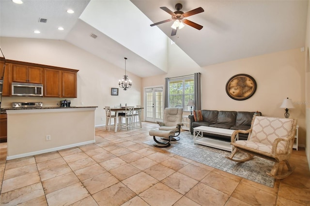 living room featuring high vaulted ceiling and ceiling fan with notable chandelier