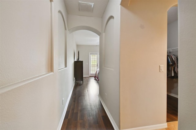 hallway with hardwood / wood-style floors