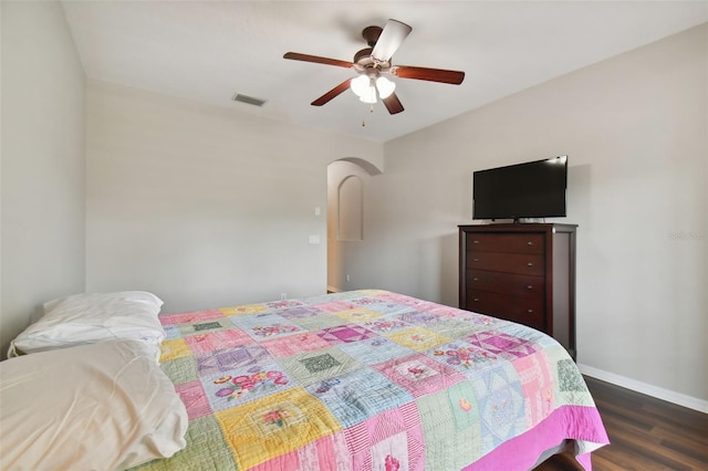 bedroom with ceiling fan and dark hardwood / wood-style floors