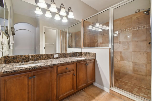 bathroom featuring tile patterned floors, vanity, and walk in shower