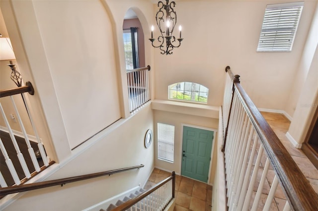 foyer with a high ceiling and an inviting chandelier