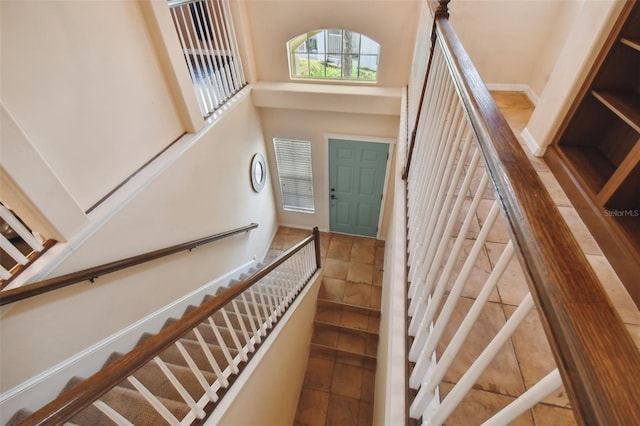 stairway with tile patterned floors