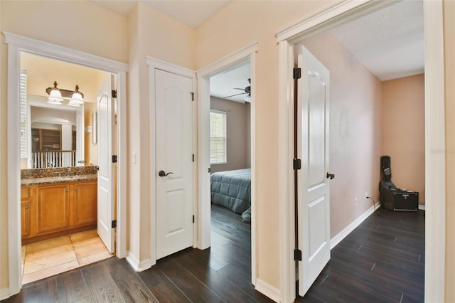 corridor with dark hardwood / wood-style floors and sink