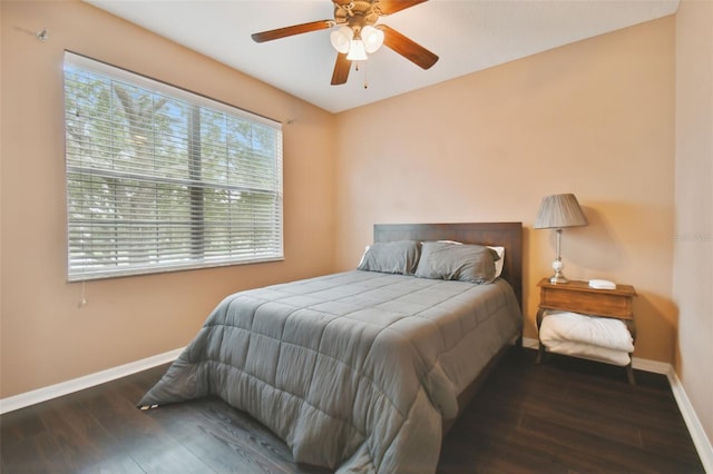 bedroom with ceiling fan and dark wood-type flooring