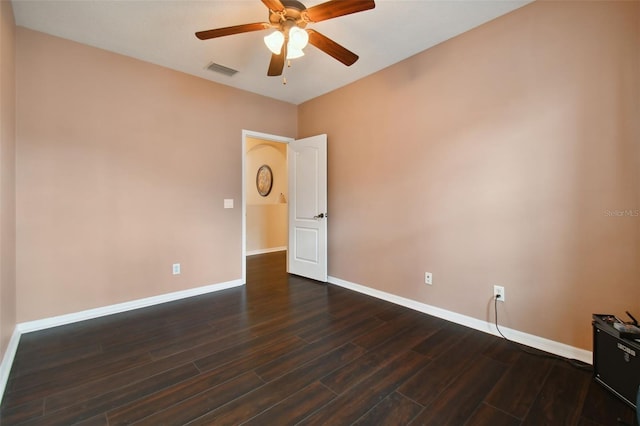 empty room with dark hardwood / wood-style flooring and ceiling fan