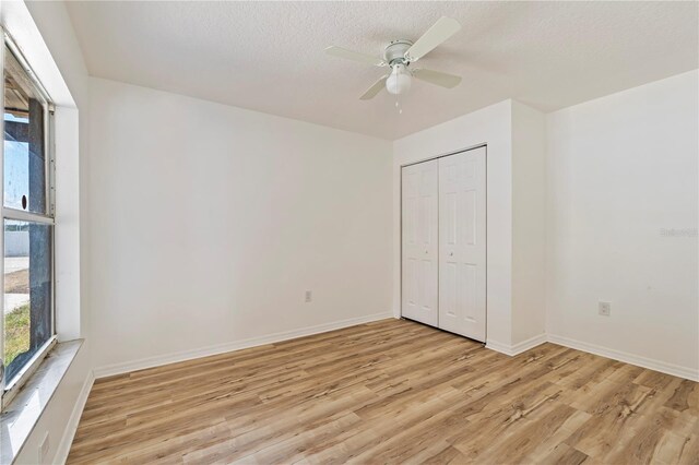 unfurnished bedroom featuring a closet, ceiling fan, and light hardwood / wood-style floors