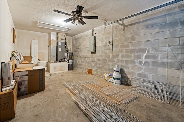 basement featuring a textured ceiling, ceiling fan, and heating utilities