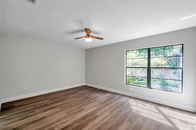 unfurnished room featuring ceiling fan and dark hardwood / wood-style flooring