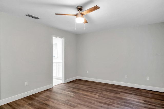 unfurnished room featuring dark wood-type flooring and ceiling fan