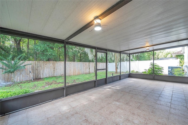 unfurnished sunroom with ceiling fan