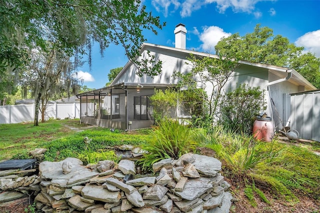 rear view of property with a sunroom