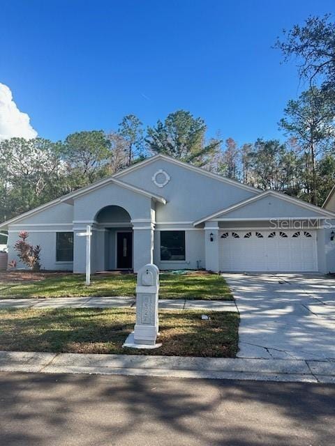 ranch-style house featuring a front yard and a garage