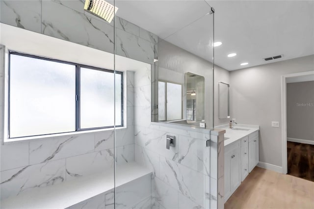 bathroom with vanity, hardwood / wood-style floors, and a shower