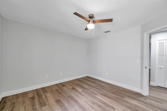 empty room featuring ceiling fan and light hardwood / wood-style flooring