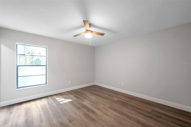 spare room with ceiling fan and dark hardwood / wood-style floors