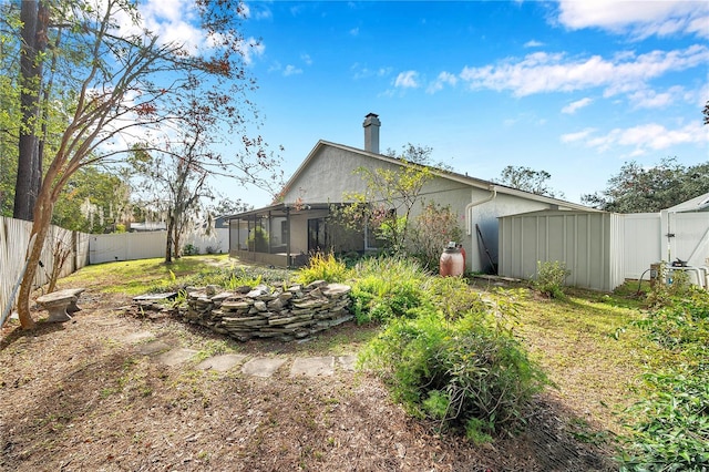 back of property featuring a sunroom