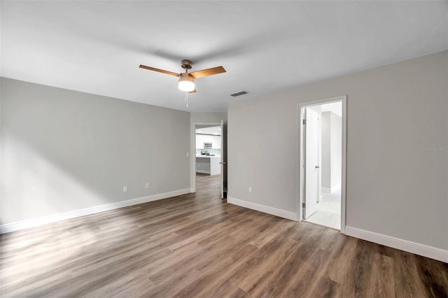 empty room featuring wood-type flooring and ceiling fan