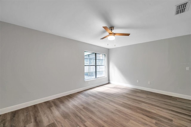 empty room with hardwood / wood-style flooring and ceiling fan