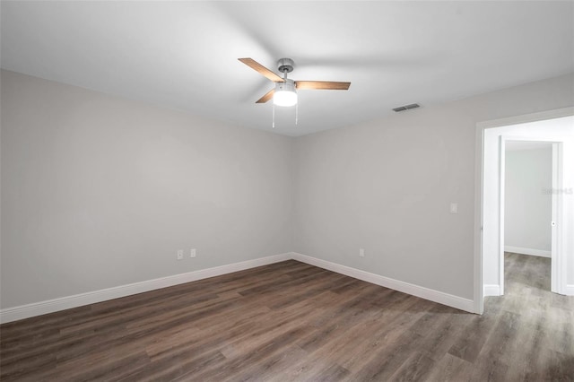 unfurnished room with dark wood-type flooring and ceiling fan