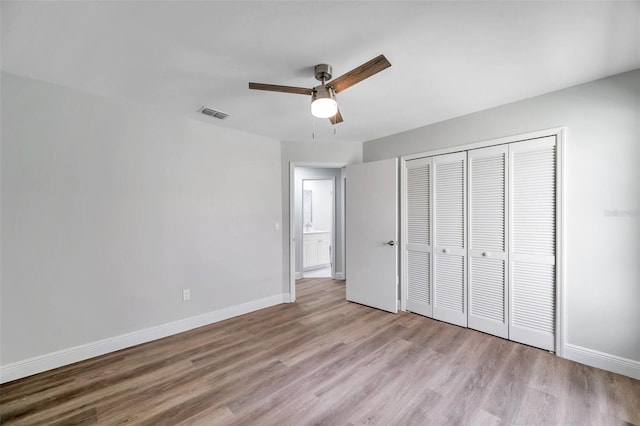 unfurnished bedroom featuring a closet, ceiling fan, and light wood-type flooring