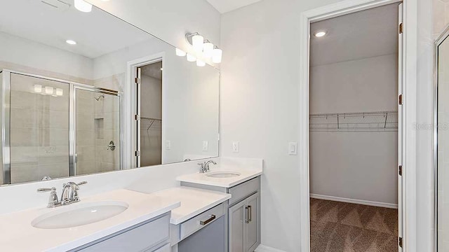 bathroom with vanity and a shower with shower door