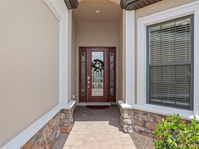 doorway to property with stucco siding