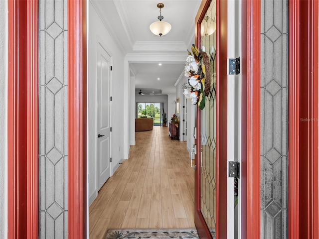 foyer featuring light wood-style flooring and crown molding