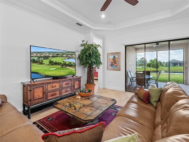 living room featuring light wood-style floors, visible vents, ornamental molding, and ceiling fan