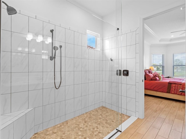 bathroom featuring crown molding, plenty of natural light, connected bathroom, and a walk in shower