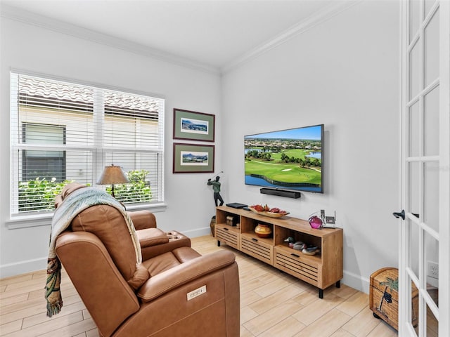 living room with light wood finished floors, crown molding, baseboards, and a wealth of natural light