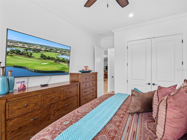 bedroom featuring ceiling fan, a closet, and crown molding