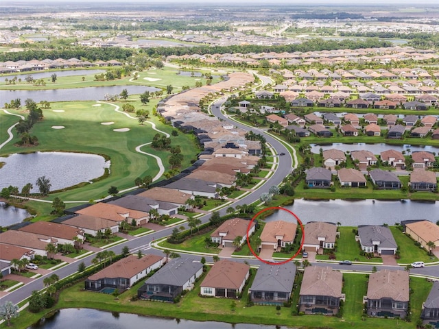 aerial view featuring a residential view, a water view, and golf course view