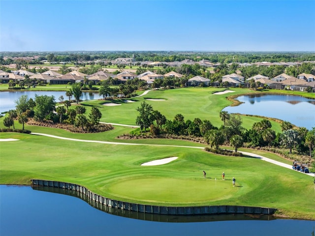 view of home's community featuring a water view, a residential view, golf course view, and a yard