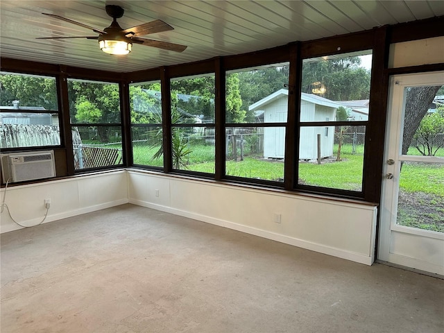 unfurnished sunroom with ceiling fan, cooling unit, and plenty of natural light