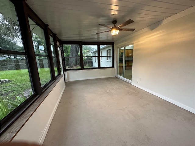 unfurnished sunroom featuring ceiling fan