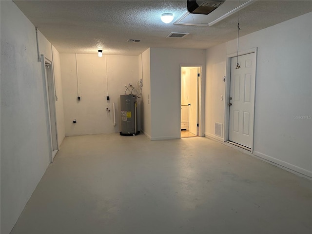 basement featuring a textured ceiling and water heater