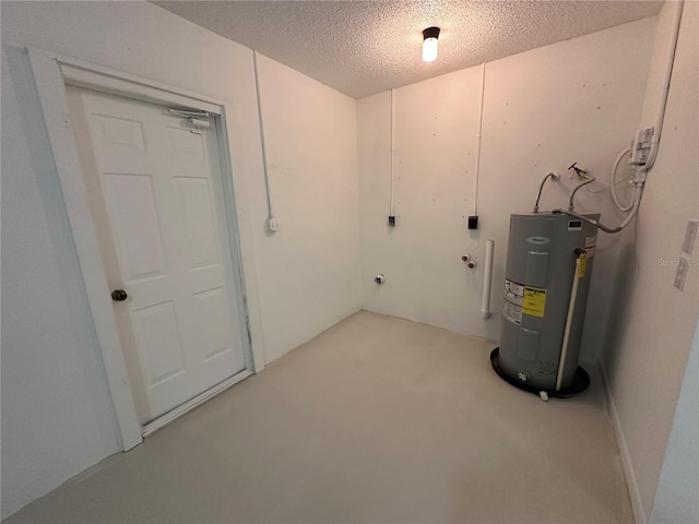 interior space featuring electric water heater and a textured ceiling