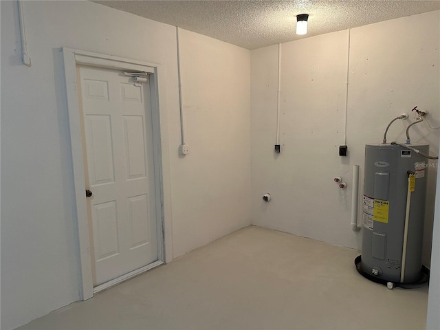 basement featuring a textured ceiling and electric water heater