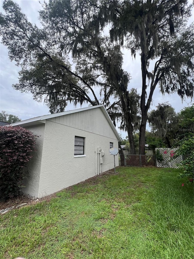 view of property exterior with a lawn