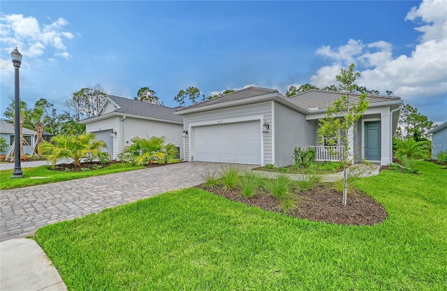 ranch-style house featuring a front yard and a garage