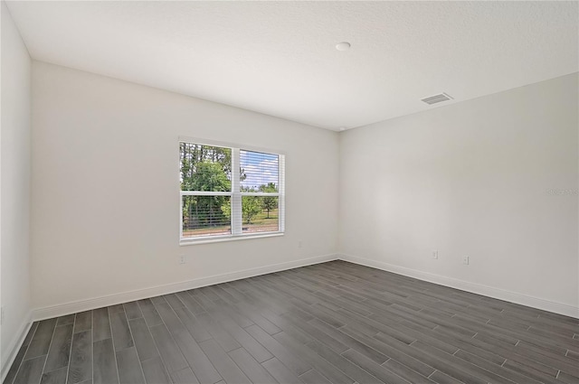 unfurnished room featuring dark wood-type flooring