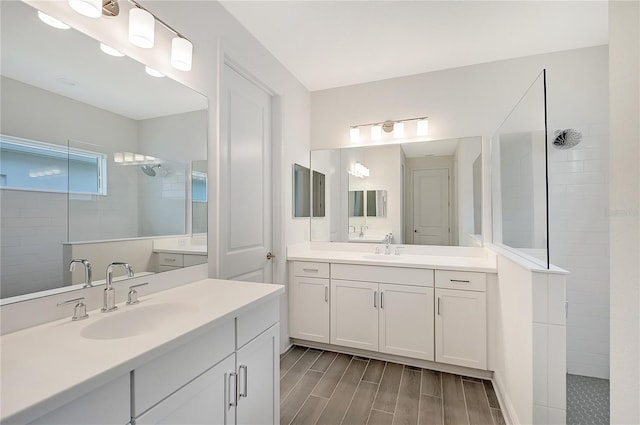 bathroom with vanity and tiled shower