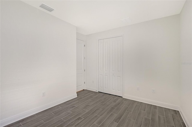 empty room featuring dark hardwood / wood-style flooring