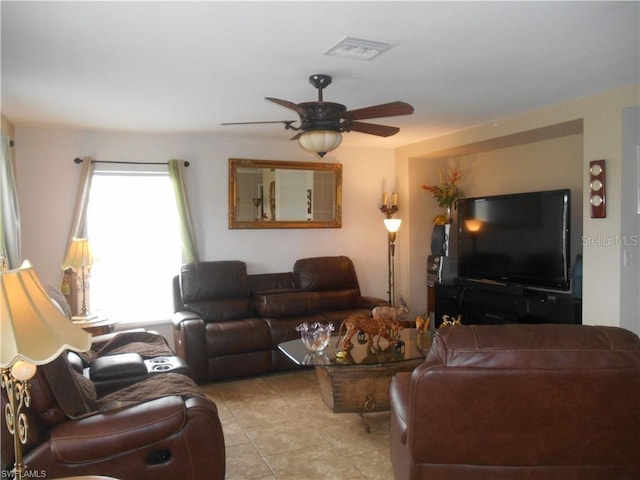 tiled living room featuring ceiling fan